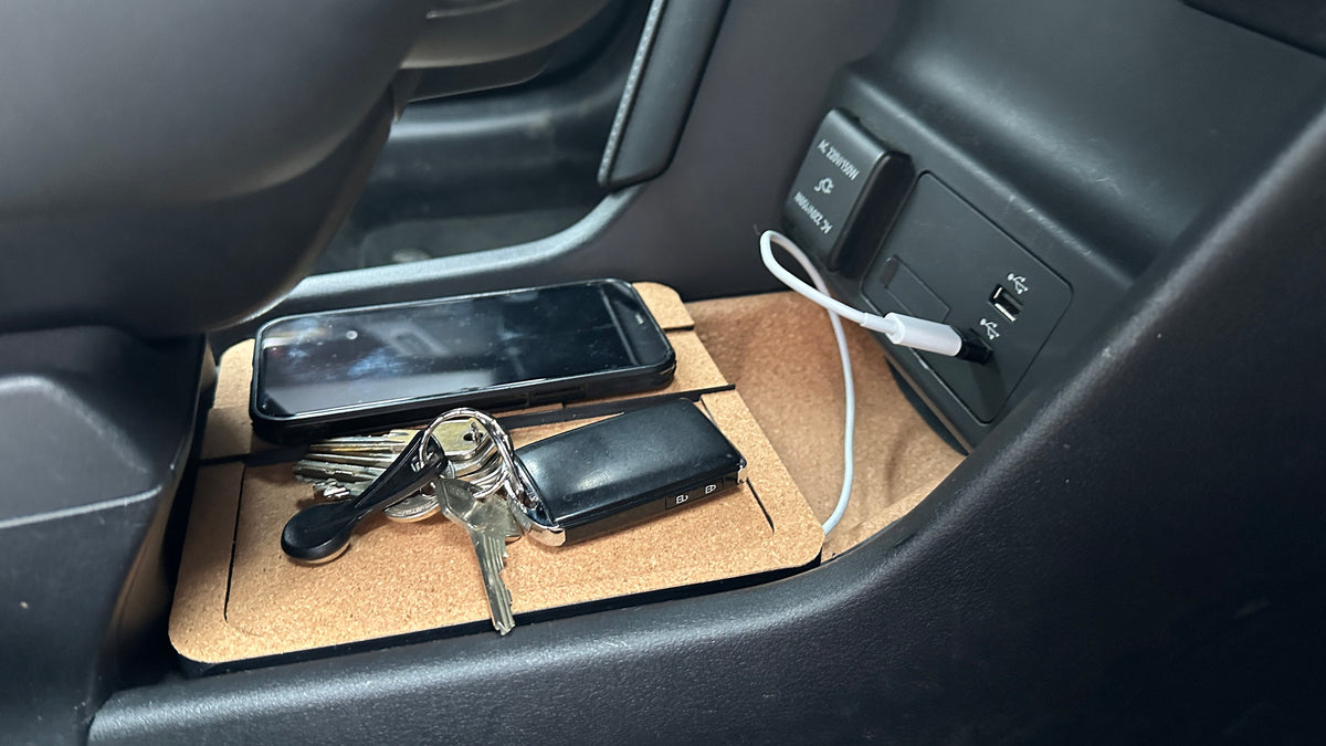 Mazda MX-30 dual console charger shown with a phone and keys