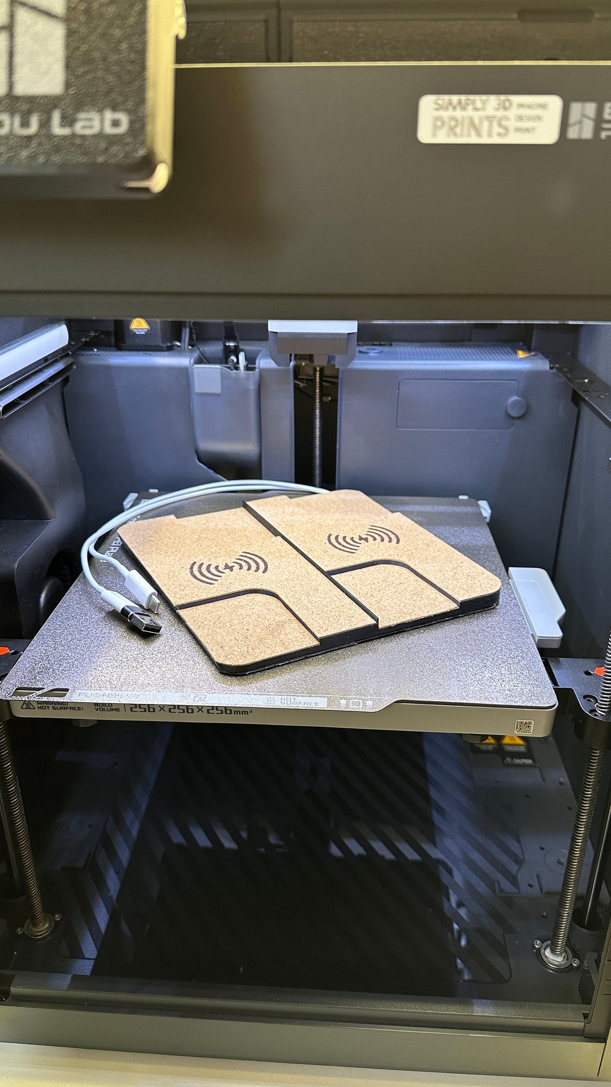 Dual cork-finished charger on a 3D printer build plate