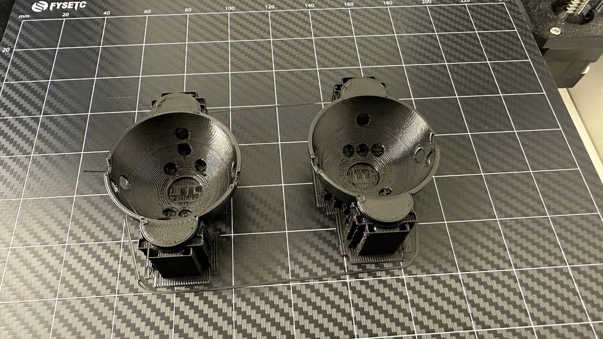 Printed ball marker halves on a 3D printer build plate