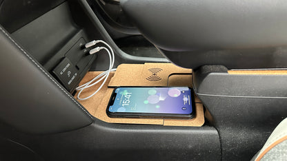 Dual cork-finished wireless charger in the lower Mazda MX-30 console with a smartphone