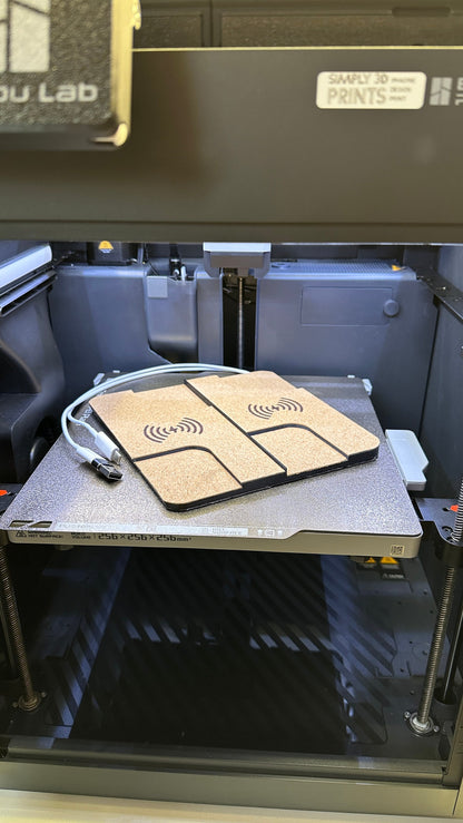 Dual cork-finished charger on a 3D printer build plate