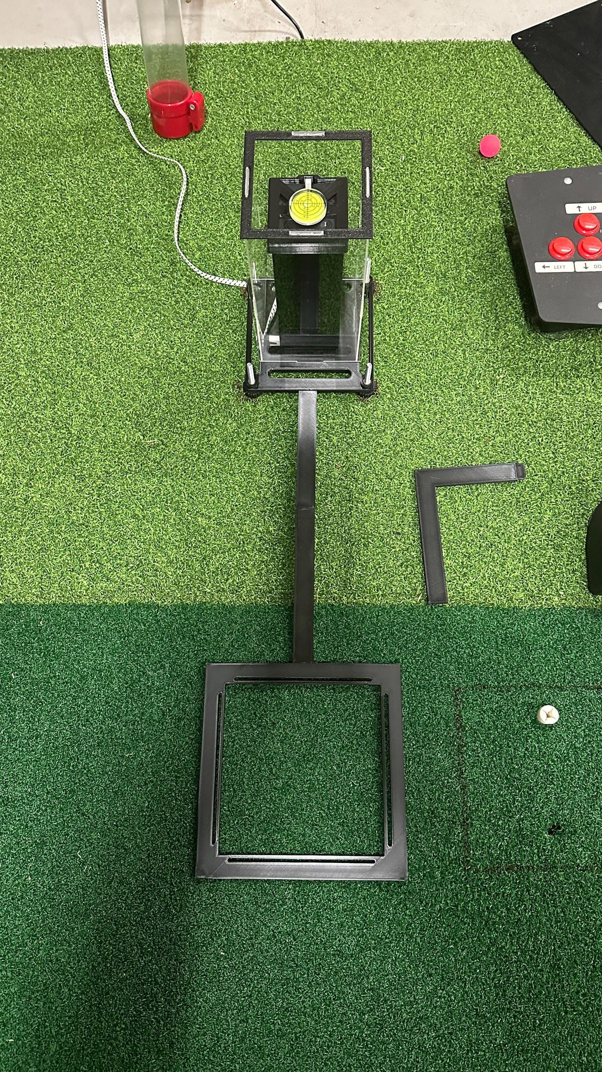 Overhead view of the Square Golf protective case and ball positioning frame with a detached L-shaped section