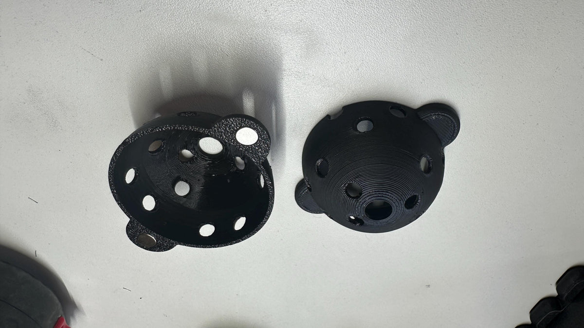 Two printed halves of the Square Golf ball marker