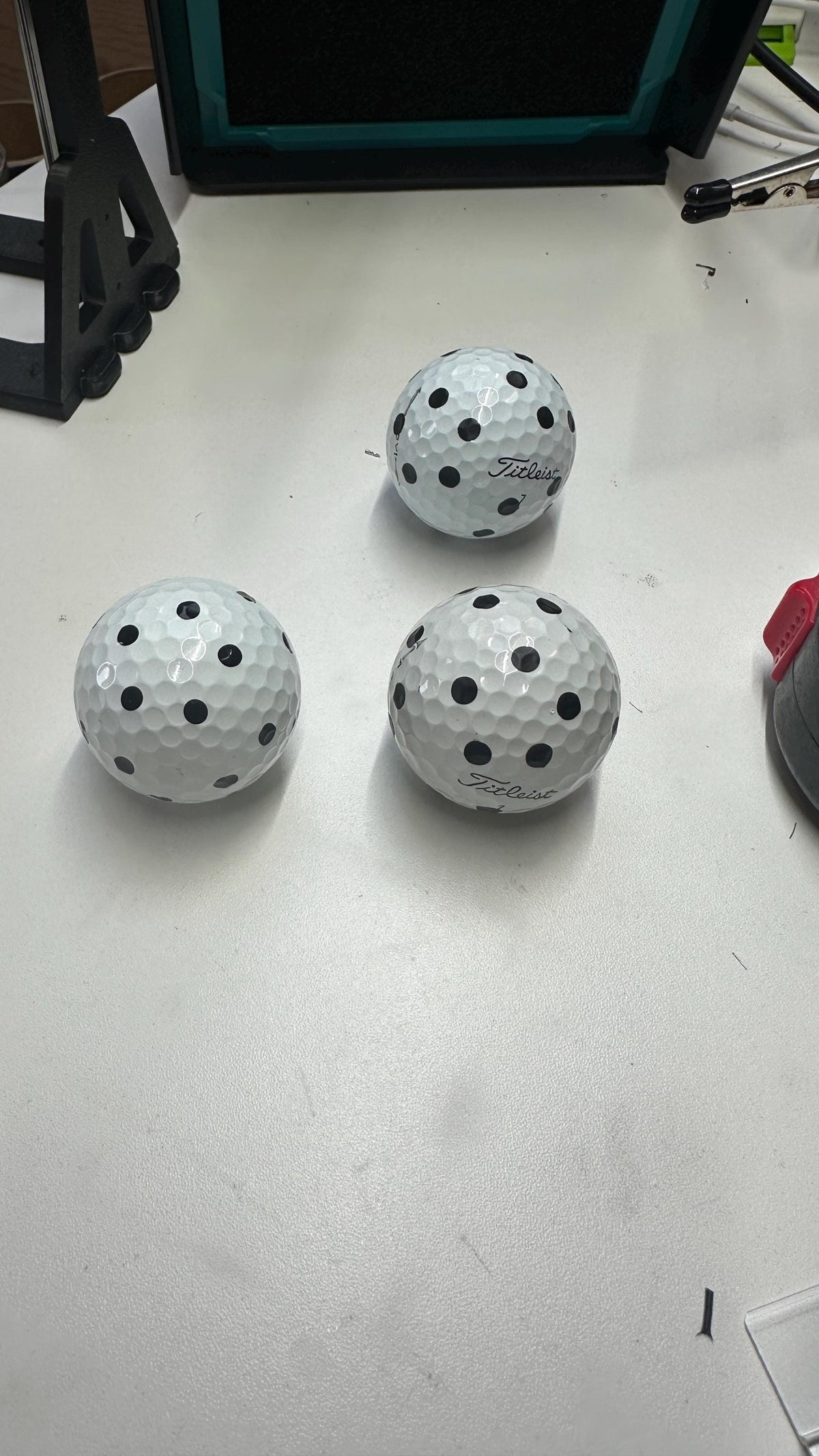 Three golf balls with repeatable markings made using the printed marker