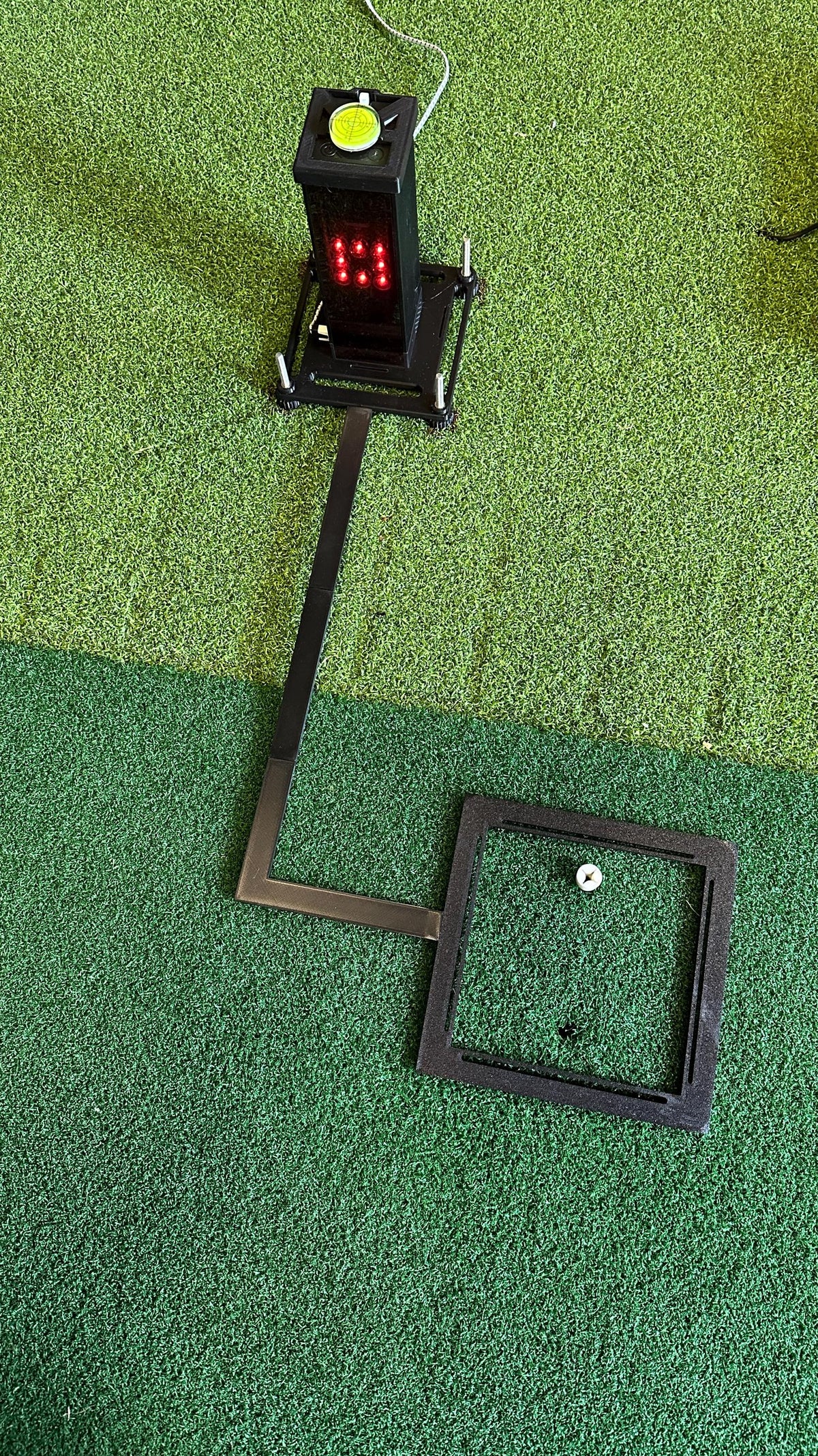 Assembled Square Golf system with ball positioning frame on a hitting mat