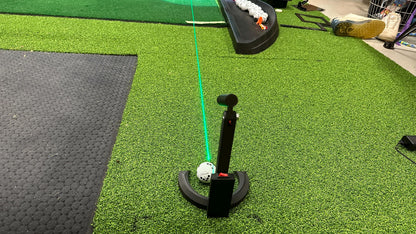 Laser alignment and putting tool shown from behind on a golf mat