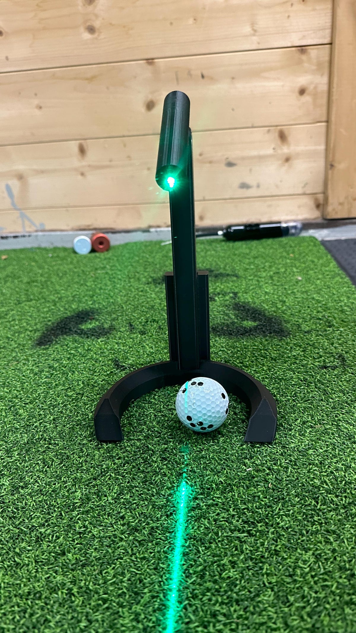 Front view of the laser alignment tool projecting a green line through the ball position