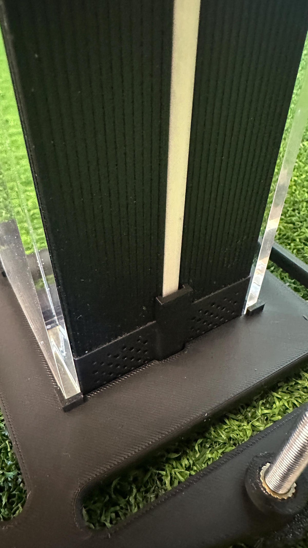 Close-up of the original Square Golf acrylic case seated in the leveling base