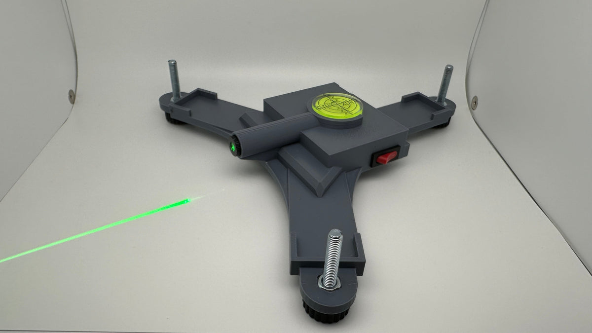 Assembled Rapsodo MLM2PRO rechargeable stand projecting a green laser line