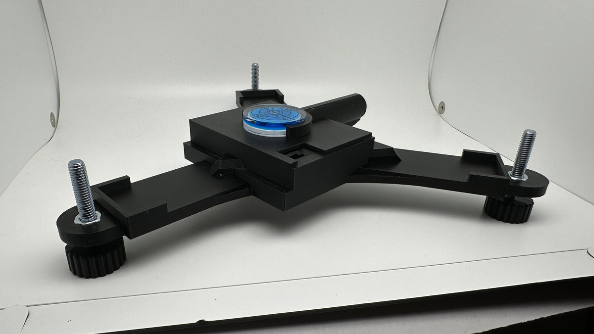 Side view of the Rapsodo MLM2PRO stand with blue bubble level and laser housing