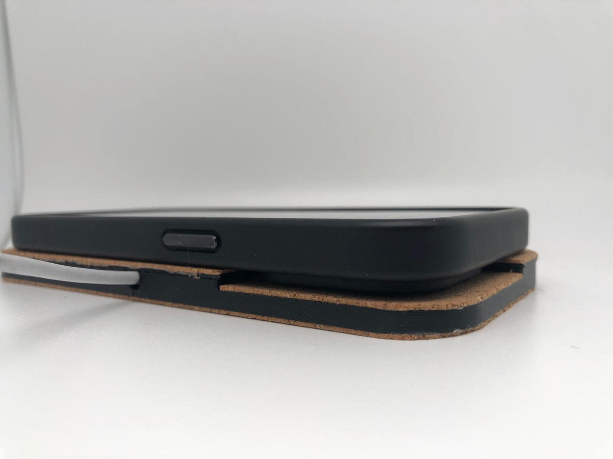 Close-up of the black charger housing beneath a smartphone